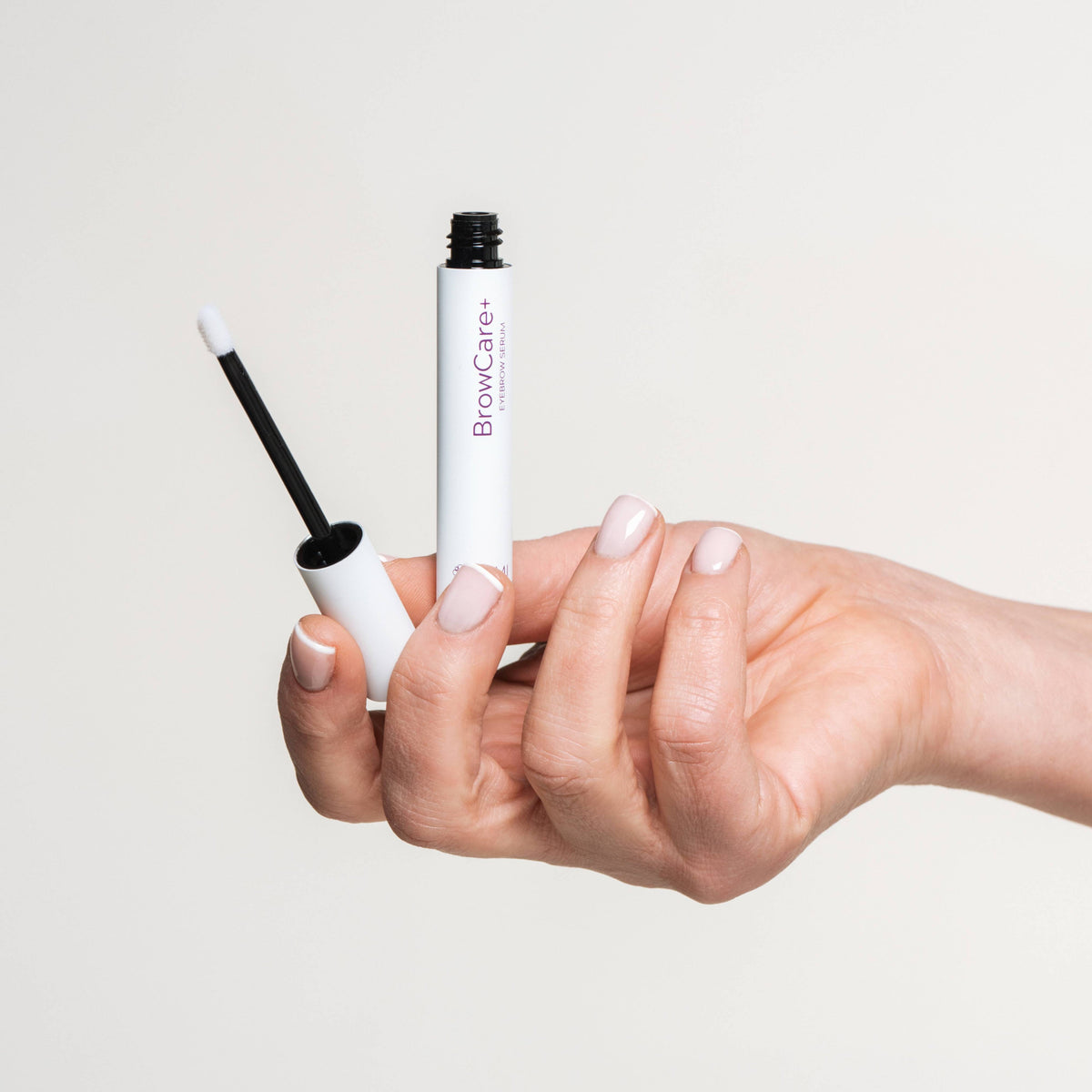 BrowCare+ Serum held in hand
